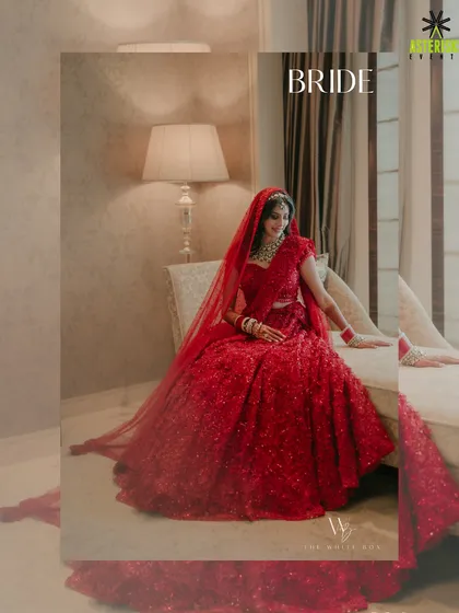 A portrait of the beautiful bride in her radiant red lehenga, captured in a quiet moment before the ceremony begins.