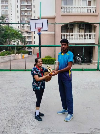 A young player receives her trophy for outstanding performance during a Ranking Day. I make sure to recognize individual effort and improvement.