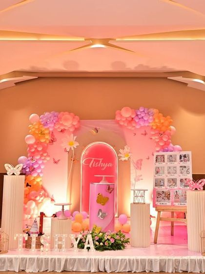 I designed this butterfly-themed stage with large, elegant butterfly wing cutouts as the main feature. The pink and orange color scheme with matching props creates a warm and cheerful atmosphere.