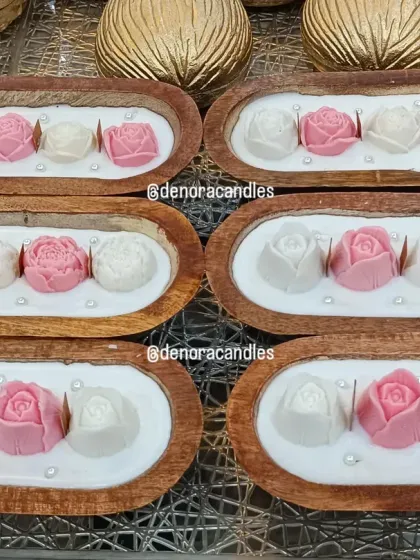 An overhead shot of the wooden boat candles, showing the neat arrangement and consistent quality across a bulk order.