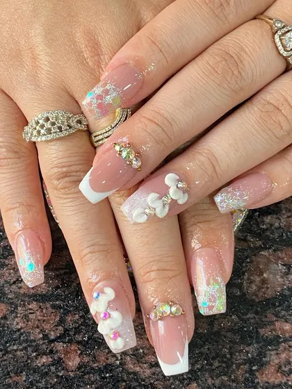 A detailed bridal set with a mix of French ombre, glitter, and intricate 3D flowers.
