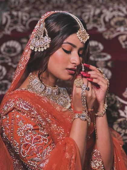 A moment of 'Qurbat' or closeness, inspired by the aesthetic of 'Heeramandi'. The makeup is rich and expressive, with a focus on the eyes and traditional detailing.