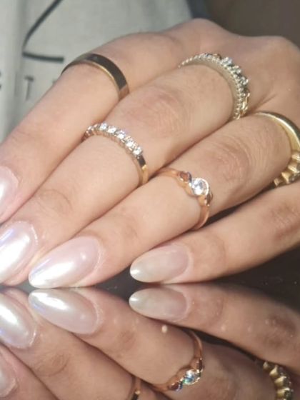 Another angle of the elegant pearlescent nails, showing how they catch the light.