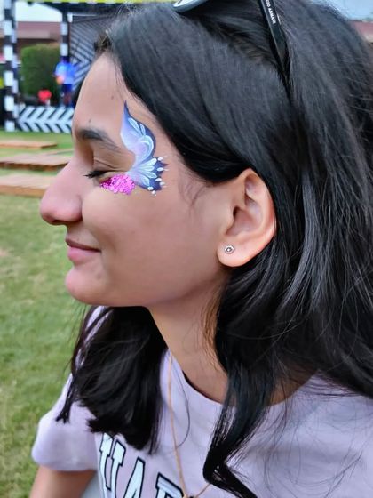 A delicate butterfly in shades of purple, accented with pink glitter.