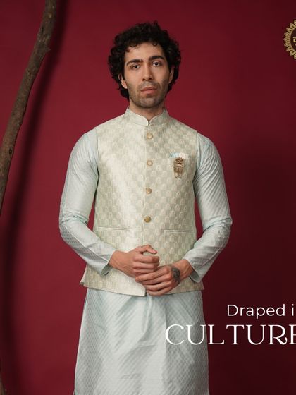 Draped in culture. A model in a light blue kurta with a beige patterned Nehru jacket, a cool and classic combination.