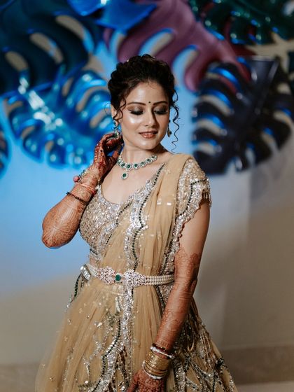 A close-up of the bride's Sangeet look, showcasing her intricate jewellery and flawless makeup. We work with top-tier makeup artists to ensure our brides look and feel their best.