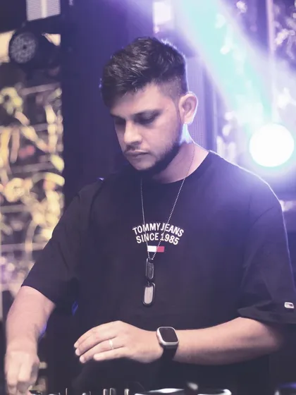 A focused shot of me twisting the knobs on my mixer, a classic "DJ at work" photo.