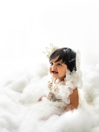 The smiles were endless during this angel-themed sitter session. The all-white setup is so classic and pure.