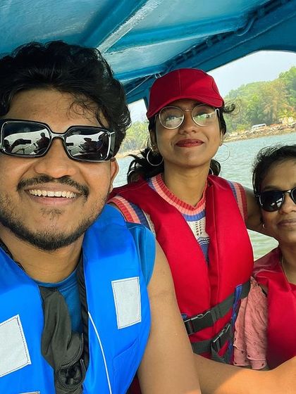 A selfie of three travelers enjoying a boat ride in Gokarna.