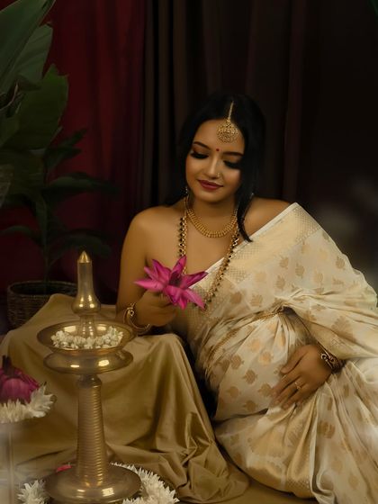 A gift of nature. Holding a lotus flower, a symbol of purity and beauty, this portrait adds another layer of meaning to the traditional maternity session.