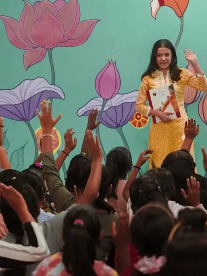 The moment a story comes to life. Here at our Library of Flowers, our volunteer captivates an audience of eager listeners. Every raised hand is a sign of curiosity sparked and a connection made, showing the immediate impact of our storytelling programs.