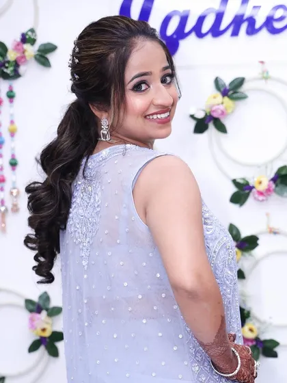 A beautiful shot of the groom's sister. Her makeup is soft and glowing, with a stylish ponytail.