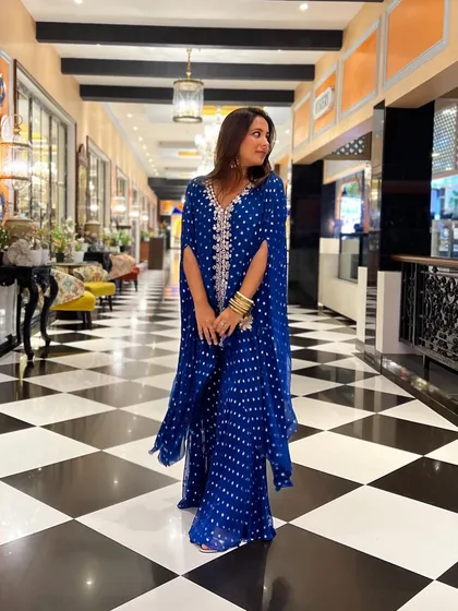 A close-up of my blue bandhani-print sharara set. The mirror-work embroidery and statement earrings were my favorite parts of this look.