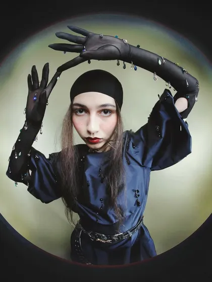 An experimental portrait from the 'Peek-a-boo' series, shot with a fisheye lens. This technique distorts perspective to create a surreal, intimate view, challenging conventional fashion photography norms.