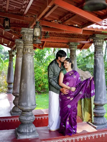 A tender forehead kiss under a traditional tiled roof. This shot captures the intimacy and cultural richness of a heritage-themed pre-wedding shoot.