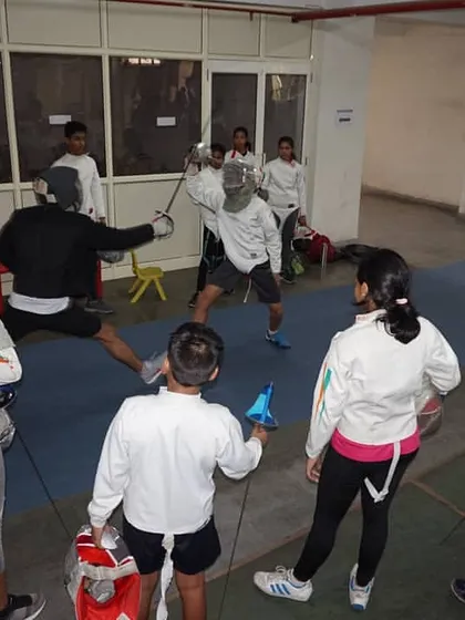 A coach and student practice parries and attacks. This direct interaction allows for immediate feedback and refinement of blade work skills.