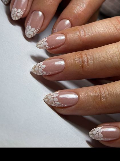 A close-up of the beautiful lace-like floral nail art, showing the intricate detail I hand-paint onto each nail for a delicate and timeless bridal look.