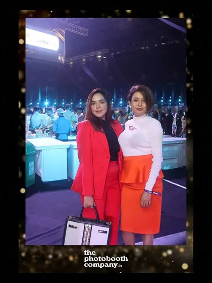 Two attendees in vibrant outfits at the India Gourmet Luxe event. The high-quality photos capture the color and style of your guests.