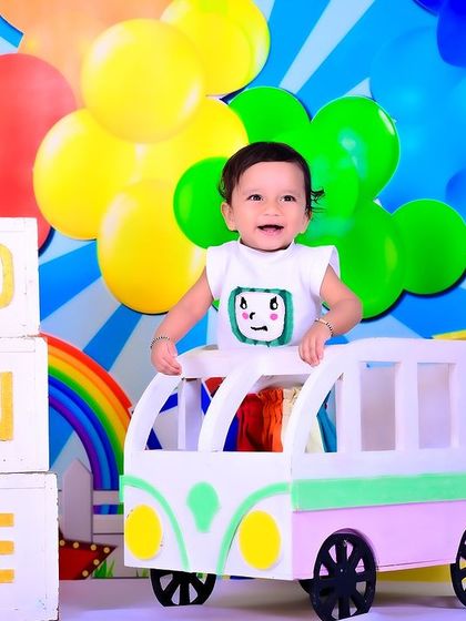 A joyful first birthday shoot with a Cocomelon theme, featuring a colorful setup and "ONE" blocks.