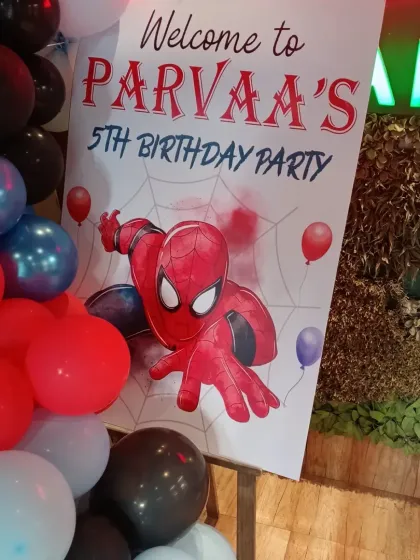 A close-up of the welcome sign for a 5th birthday Spiderman party, featuring the iconic superhero.
