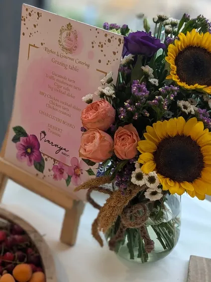 Another look at the beautifully designed menu and floral decor for the Varnya salon launch. The combination of sunflowers and roses added a cheerful and elegant touch.