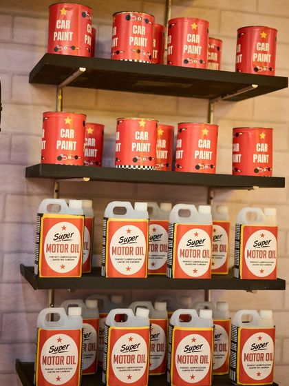 No detail is too small. I created these custom-labeled "Car Paint" and "Super Motor Oil" props to fully flesh out the garage theme.