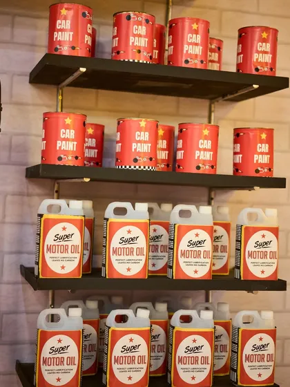 No detail is too small. I created these custom-labeled "Car Paint" and "Super Motor Oil" props to fully flesh out the garage theme.