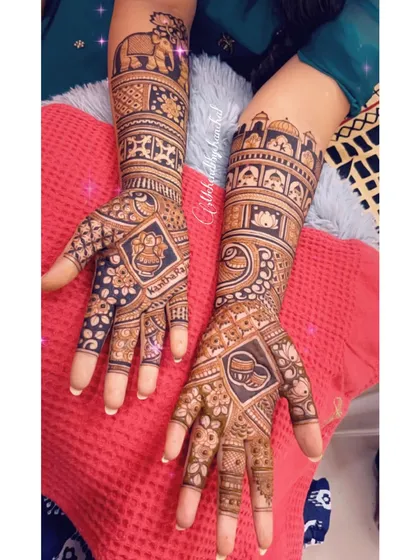 This bridal design features a mix of traditional symbols, including a kalash, a diya, and a royal elephant.
