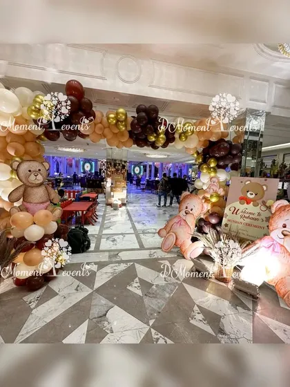 The grand entrance to a teddy bear-themed Mundan ceremony. A balloon arch in earthy tones and large, cute teddy bear cutouts welcome guests to the celebration.