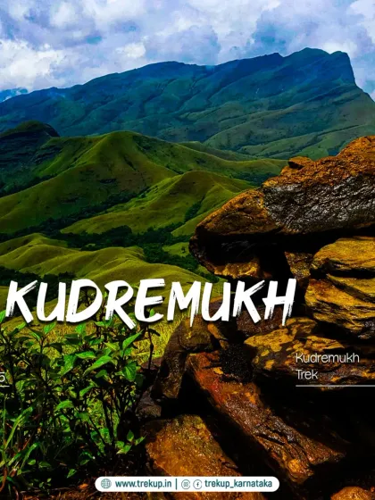 The rolling green hills of Kudremukh, often called the "Switzerland of Karnataka," seen from a rocky viewpoint.