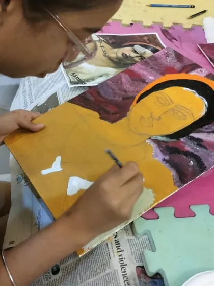 A close-up of the detailed work that goes into creating a portrait. This student is focused on capturing the features and expression, learning valuable acrylic painting techniques along the way.