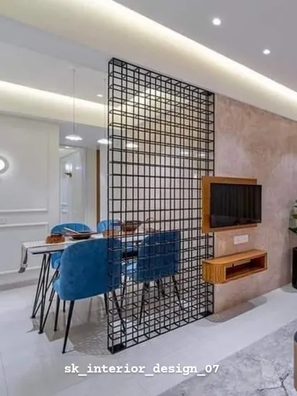 A metal grid partition separates the dining area while maintaining a visual connection. This industrial-style element adds an edgy, modern touch to the home.