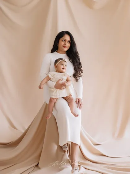 Elegance in simplicity. This mother and child portrait, with its neutral color palette and soft fabric, exudes a quiet confidence and deep love.