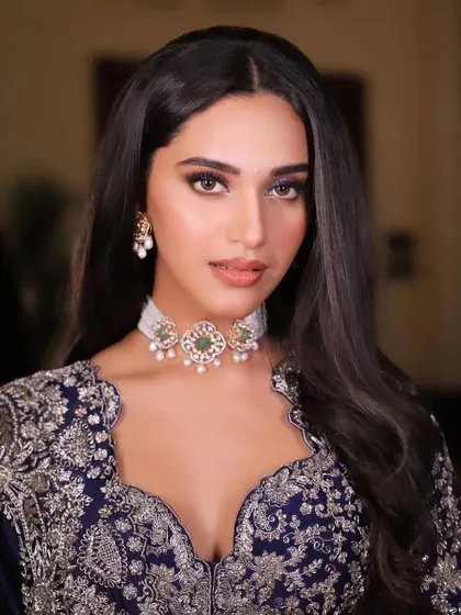 A close-up portrait highlighting the delicate choker and the beautiful scalloped neckline of the blouse.