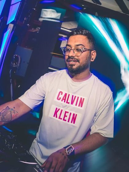 Dialed in and focused on the mix at a packed club. The right lighting and a powerful sound system are key to creating an immersive experience for any party.