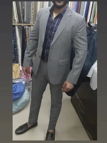 A classic grey pinstripe suit on a client in my shop. This is a timeless business essential, and my tailoring ensures it fits comfortably for all day wear.