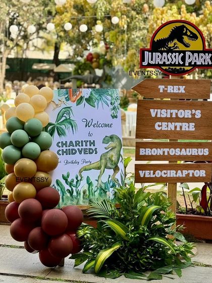 The welcome area for the dinosaur party, featuring a Jurassic Park signpost pointing the way to different 'attractions'.