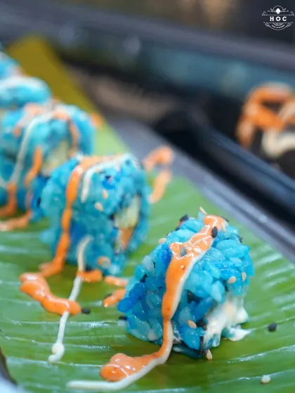 We love to surprise and delight with our global cuisine. This vibrant blue vegetarian sushi, served on a fresh banana leaf, showcases our creative approach to food, ensuring every dish is a conversation starter.