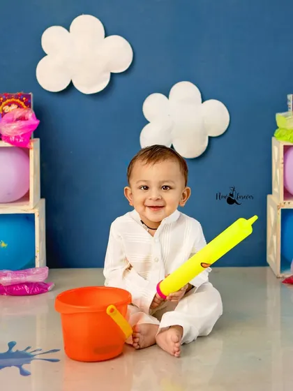 Ready for some fun with his pichkari! This little one's happy smile shows he's having a wonderful time at his first Holi photoshoot.