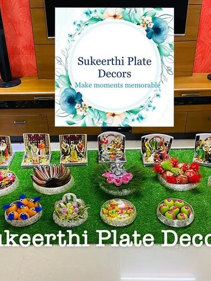 For this engagement in Namakkal, I arranged 15 German silver plates on a grass floor. The setup includes photo frames of deities and beautifully decorated gift items.