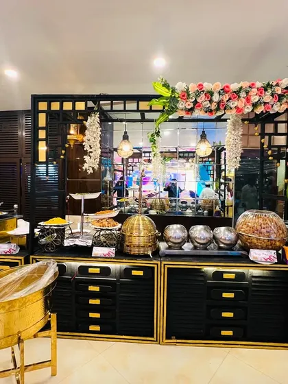 Another view of our versatile black setup, complete with a chocolate fountain and floral arch for a touch of elegance.