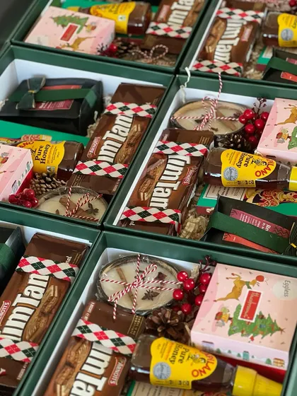 An assembly line of Christmas cheer! Packing these corporate gift boxes is a huge team effort, and we make sure every single one is perfect.