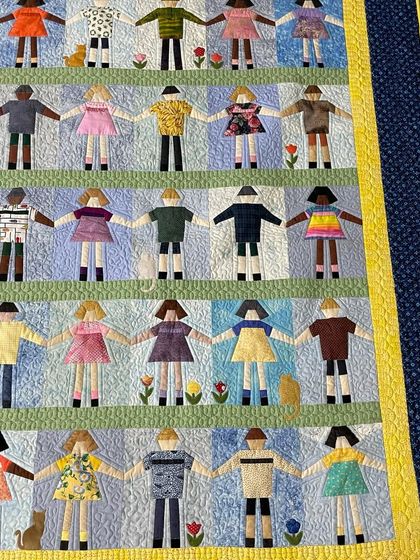 A closer look at the charming details of the Paper Doll quilt.