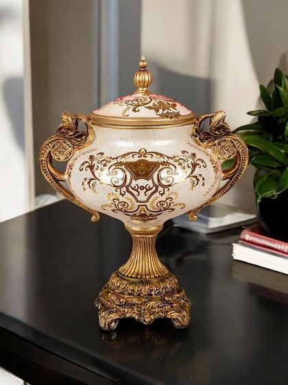 This lidded Victorian urn is both beautiful and functional. The intricate gold detailing and classic shape make it a sophisticated accent piece, perfect for adding a touch of historical elegance to your decor.