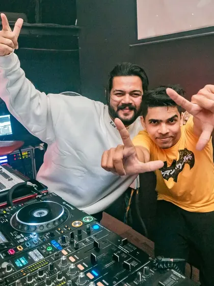Sharing a moment with a fellow artist behind the decks. It's all about collaboration and inspiration.