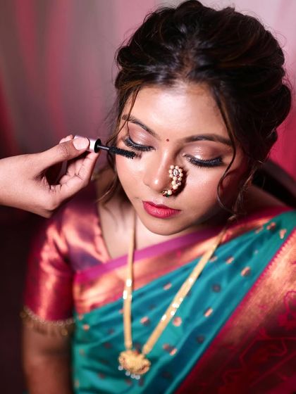 This is what I mean by makeup that enhances, not changes. A behind-the-scenes shot of me applying mascara to complete this beautiful, natural bridal look.