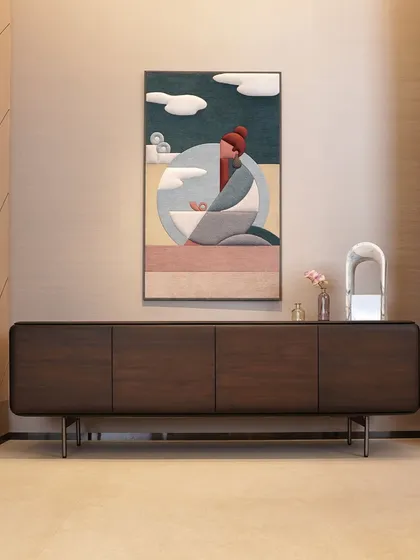 Here, our minimalist dark wood console provides a grounding element for the vibrant wall art above it. Its clean lines, handleless cabinet doors, and slim metal legs demonstrate our approach to creating refined, handcrafted furniture that complements your space.