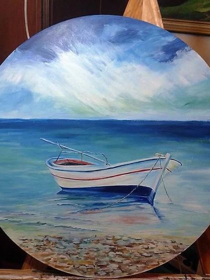 A peaceful seascape on a round canvas, demonstrating how to paint calm waters and dramatic skies in our acrylic classes.