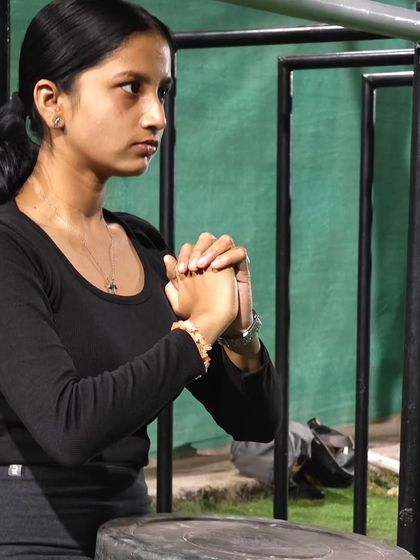 Mindset is everything. This athlete is focused as she prepares for a set of wall sits, building isometric leg strength.
