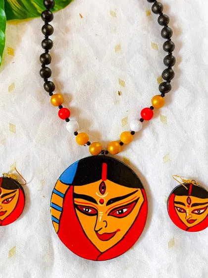 Another interpretation of the Durga face, this design is a tribute to the goddess. The simple, clean lines and classic color palette make it a timeless piece of devotional art.